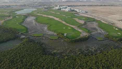 Drone-view-of-Al-Zorah-golf-course-in-Ajman,-The-18-Hole-golf-course-has-been-designed-by-Nicklaus-Design,-United-Arab-Emirates