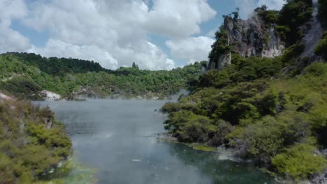 Run-off-water-from-thermal-crater-to-steaming-volcanic-lake-in-New-Zealand
