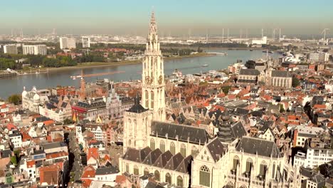 Cathedral-of-Our-Lady-amid-Antwerp-cityscape-and-Scheldt-river,-Belgium---Aerial-wide-Panoramic-shot