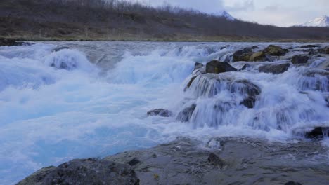 Panning-shot-of-strong-splashing-icelandic-Hlauptungufoss-Waterfall-over-mossy-rocks