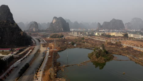 Aerial:-Yangshuo-city-construction,-road-infrastructure-and-urban-development