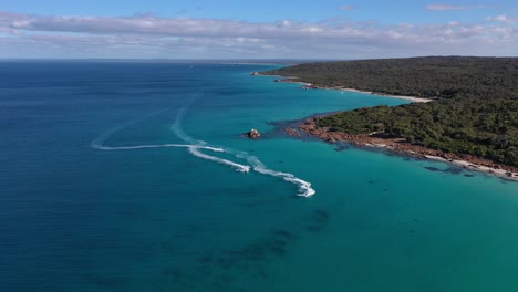 Aerial-of-Jet-Skies-in-Turquoise-Ocean-Water-by-Meelup-Beach,-Cape-Naturaliste,-Australia,-Wide-Drone-Shot