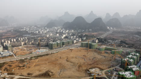 Large-city-building-construction-site,-Yangshuo-China-development,-aerial-view
