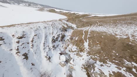 Fast-drone-shots-of-the-snowy-landscape-of-Varatic,-Moldova