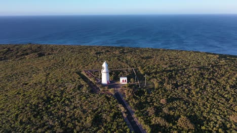 Cape-Naturaliste-Lighthouse,-Drone-Aerial-View-of-Landmark,-Forest-and-Horizon,-Australia
