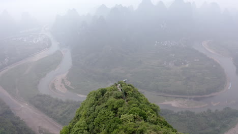 Yangshuo-Damian-Mountain-lookout,-karst-mountain-landscape,-4K-aerial-misty-view