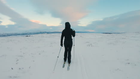 Die-Kamera-Folgt-Einer-Langläuferin-Auf-Einer-Loipe-Auf-Einem-Schneebedeckten-Berg-In-Nordschweden
