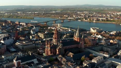 Acercándose-A-La-Iglesia-Catedral-De-Mainz-En-Un-Cálido-Día-De-Primavera-Mostrando-El-Río-Azul-En-La-Parte-De-Atrás