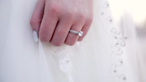 Diamond-Wedding-Ring-on-Hand-of-Bride-in-White-Dress