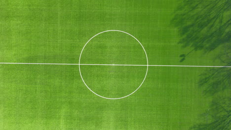 High-top-down-view-of-center-spot-on-soccer-field---slowly-zooming-out