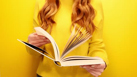 Red-hair-woman-reading-book-isolated-on-yellow-background