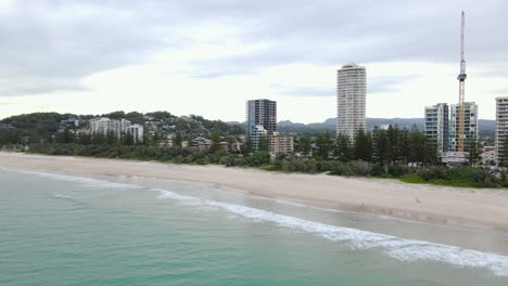 Aerial-View-Of-Sandy-Beach-And-Cityscape-At-Daytime-In-Burleigh-Heads,-Gold-Coast,-Queensland,-Australia---drone-shot