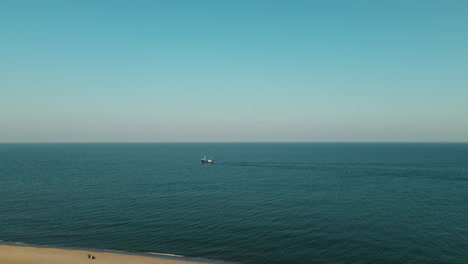 Small-Fisher-ship-boat-in-the-baltic-sea,-Hel-city-Poland-drone-point-of-view