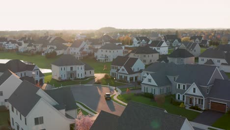 Aerial-of-upscale-homes-and-housing-development-at-sunrise,-sunset