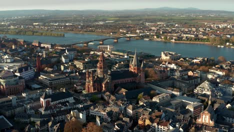 Flying-closer-to-the-Cathedral-church-of-Mainz-with-drone-shots-on-a-warm-spring-day-showing-the-blue-river-in-the-back