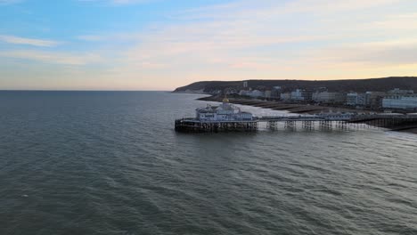 Eastbourne-Pier-and-town-at-Sunset-Sussex-Uk-Aerial-wide-POV-view-4K
