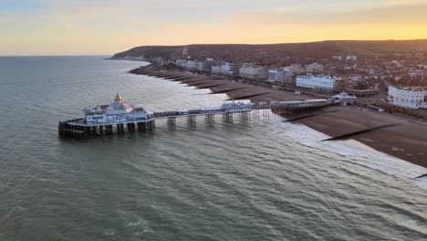 Eastbourne-Pier-and-town-at-Sunset-Sussex-Uk-Aerial-pull-back-reveal-view-4K