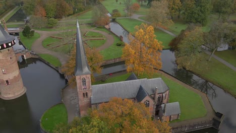 Private-chapel-in-historic-gardens-of-Castle-De-Haar-in-Holland,-aerial