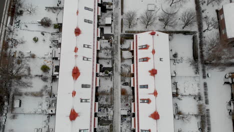 Top-down-view-of-apartment-blocks-covered-in-snow
