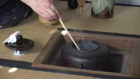 Ladle-of-hot-water-is-poured-into-Japanese-tea-bowl-during-Japanese-tea-ceremony-