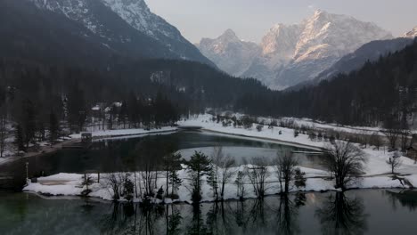Lake-Jasna,-Slovenia,-against-Alps-mountains