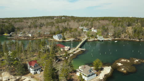 Scenic-Aerial-of-Maine-Coastal-village-with-beautiful-green-water-on-a-sunny-day