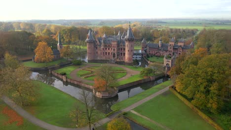 Fairytale-castle-De-Haar-in-Holland-with-magical-morning-sunlight,-aerial