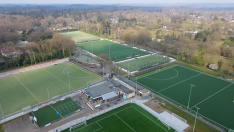 Aerial-of-soccer-and-hockey-fields-at-the-edge-of-a-small-town