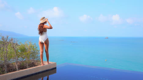 Beautiful-Girl-at-Side-of-Infinity-Pool-Looking-over-the-Ocean