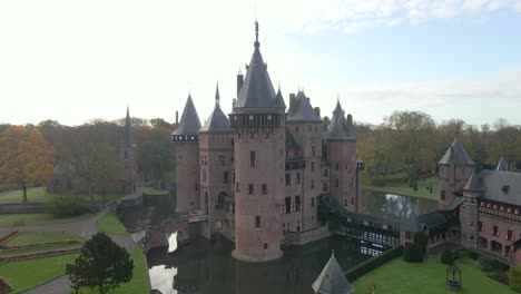 Medieval-Castle-De-Haar-with-water-moat-in-Holland,-aerial-past-main-tower