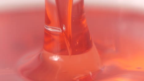 Red-liquid-is-being-spilled-in-laboratory,-macro-close-up-view