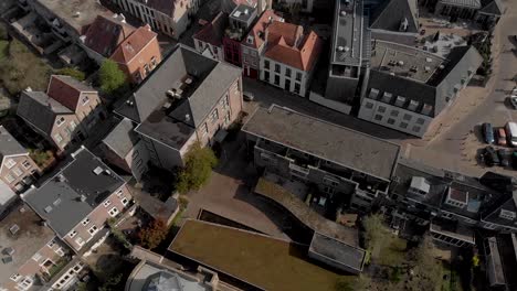 Top-down-reveal-of-historic-Bourgonje-stronghold-tower-and-city-wall-among-the-new-and-old-parts-of-the-Dutch-medieval-Hanseatic-cityscape-of-Zutphen