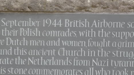 Medium-pan-over-World-War-2-memorial-stone-at-the-Old-Church-in-Oosterbeek,-the-Netherlands