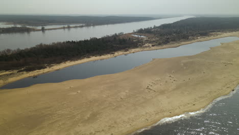 Aerial-view-of-Mikoszewskie-lake-and-Vistula-River-sandy-banks-in-Nature-Reserve-Mewia-Lacha,-Poland,-forward-flight