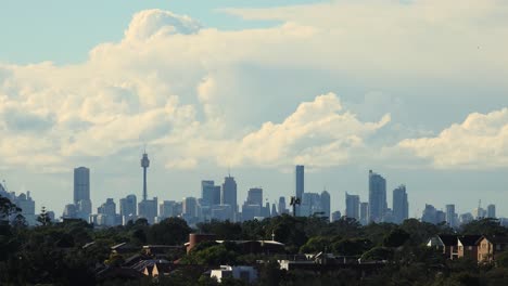 Clouds-passing-over-Sydney-CBD-in-the-morning,-view-from-the-rooftop-in-Olympic-Park,-time-lapse