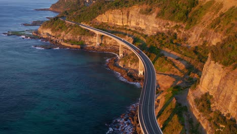 Picturesque-View-Of-The-Sea-And-Coastline-With-Idyllic-Cliffs-By-The-Sea-Cliff-Bridge-In-NSW-Australia---aerial-shot