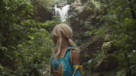 Epic-waterfall-flowing-over-a-cliff-with-an-anime-cosplayer-turning-around-to-look-at-it