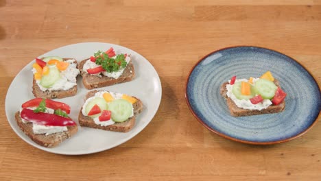 Showing-two-ceramic-plates:-one-with-four-delicious-sandwiches,-second-with-one-colorful-sandwich