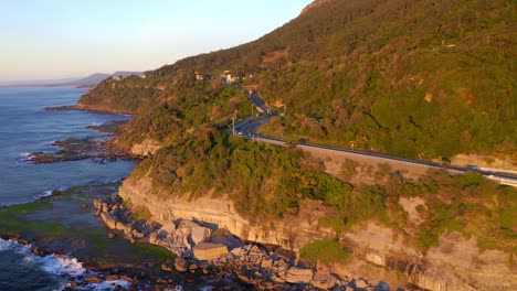 Highway-On-The-Edge-Of-Rocky-Cliffs-With-Dense-Forest-Along-Grand-Pacific-Drive,-New-South-Wales-Australia
