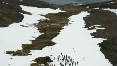 Aerial-of-hiking-expedition-high-in-mountains-with-snow,-Iceland