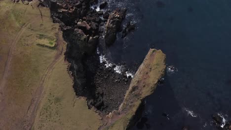 Steep-cliffs-at-shore-of-Iceland-shaped-by-years-of-sea-erosion,-aerial