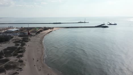 AERIAL:-Klaipeda-Port-near-Melnrage-Beach-on-a-Cloudy-Day-with-Calm-Baltic-Sea