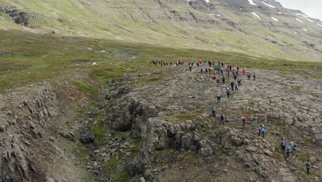 Hiking-expedition-in-Iceland-with-large-group-of-people,-aerial