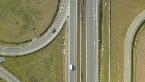 Top-view-on-complicated-speed-highway-road-S7-Cdry-intersection,-Poland,-Aerial-drone-moving-forward-along-the-highway-looking-down