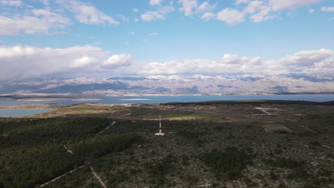 Panoramic-aerial-over-protected-natural-forest-with-views-over-Adriatic-Sea,-mountains-range-Velebit-and-nearby-islands-in-Zadar-county,-Croatia