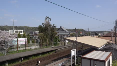 Locked-off-view-of-tiny-train-station-in-typical-rural-Japanese-setting