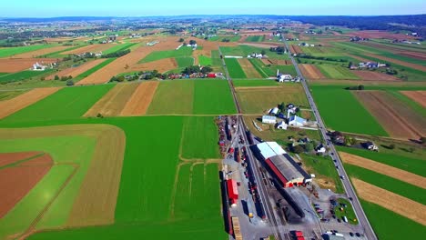 An-Aerial-View-of-Pennsylvania-Farmlands-and-Businesses-With-Multiple-Color-and-Shape-Fields-on-a-Sunny-Day