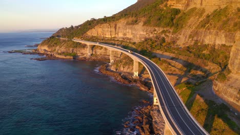 Sea-Cliff-Bridge-During-Golden-Hour-Of-Sunrise-With-Mountain-Cliffs-In-NSW,-Australia