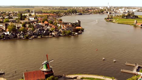 Fly-over-River-Zaan-from-Zaanse-Schans-to-Zaandijk-Town,-Netherlands---Aerial