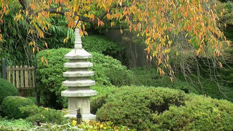 Stone-pagoda-and-bamboo-gate-in-a-Japanese-garden-in-autumn